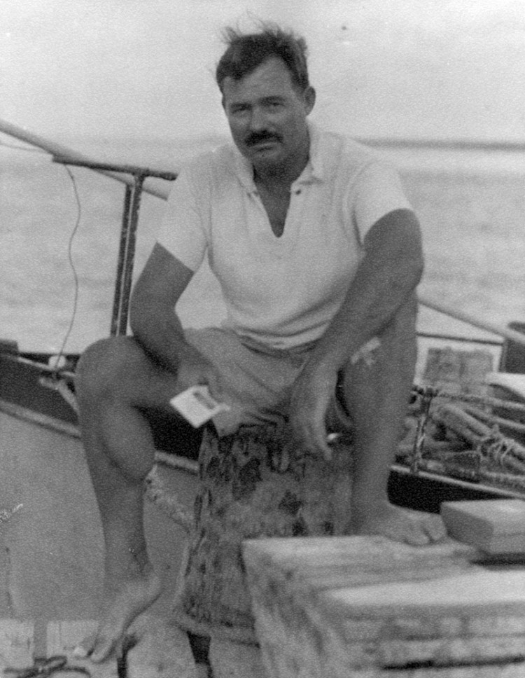 EH6670P   1930s
Ernest Hemingway sitting on a dock next to the Pilar, 1930s.  Photographer unknown in the Ernest Hemingway Collection of the John F. Kennedy Presidential Library and Museum, Boston.